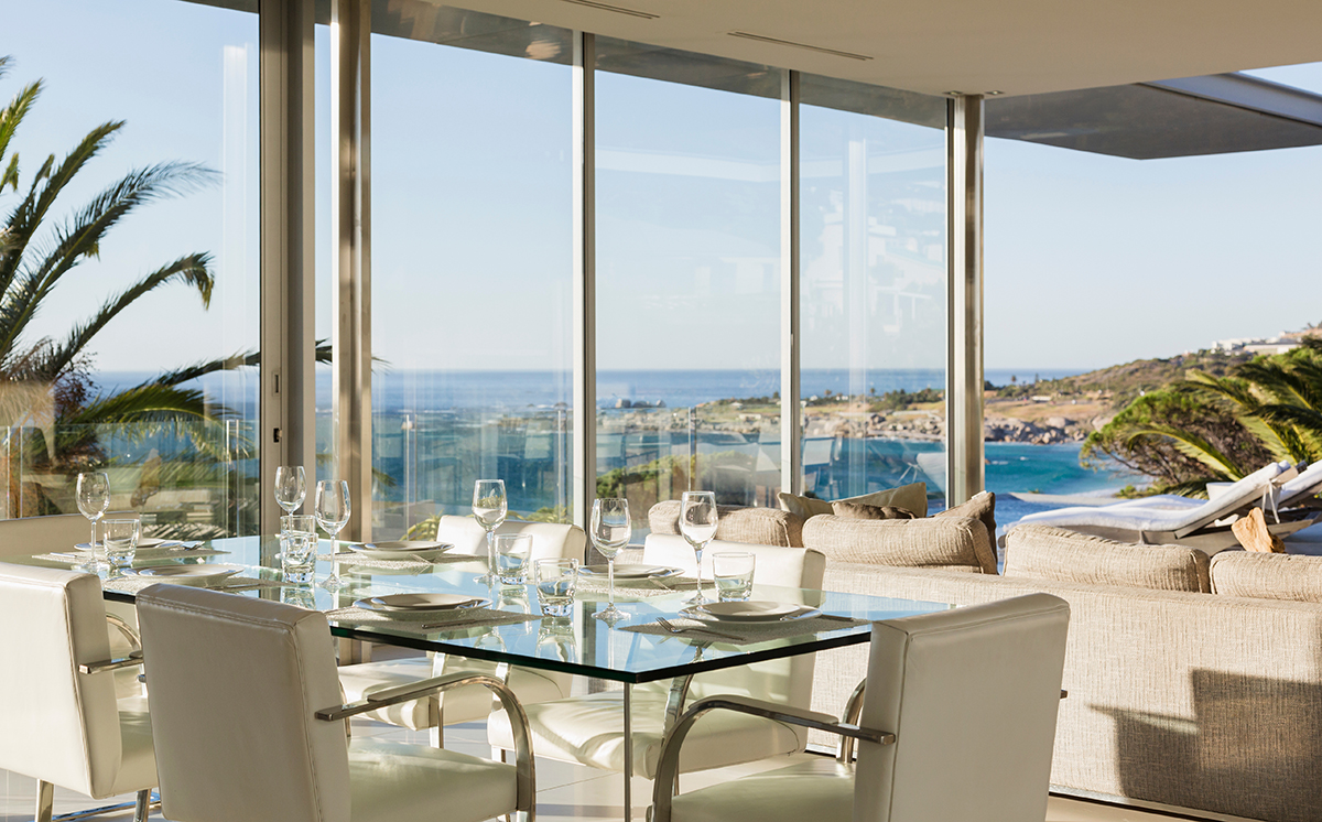 Set table in modern dining room overlooking ocean