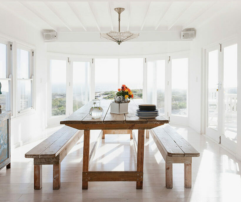 Wooden table and benches in sunny dining room