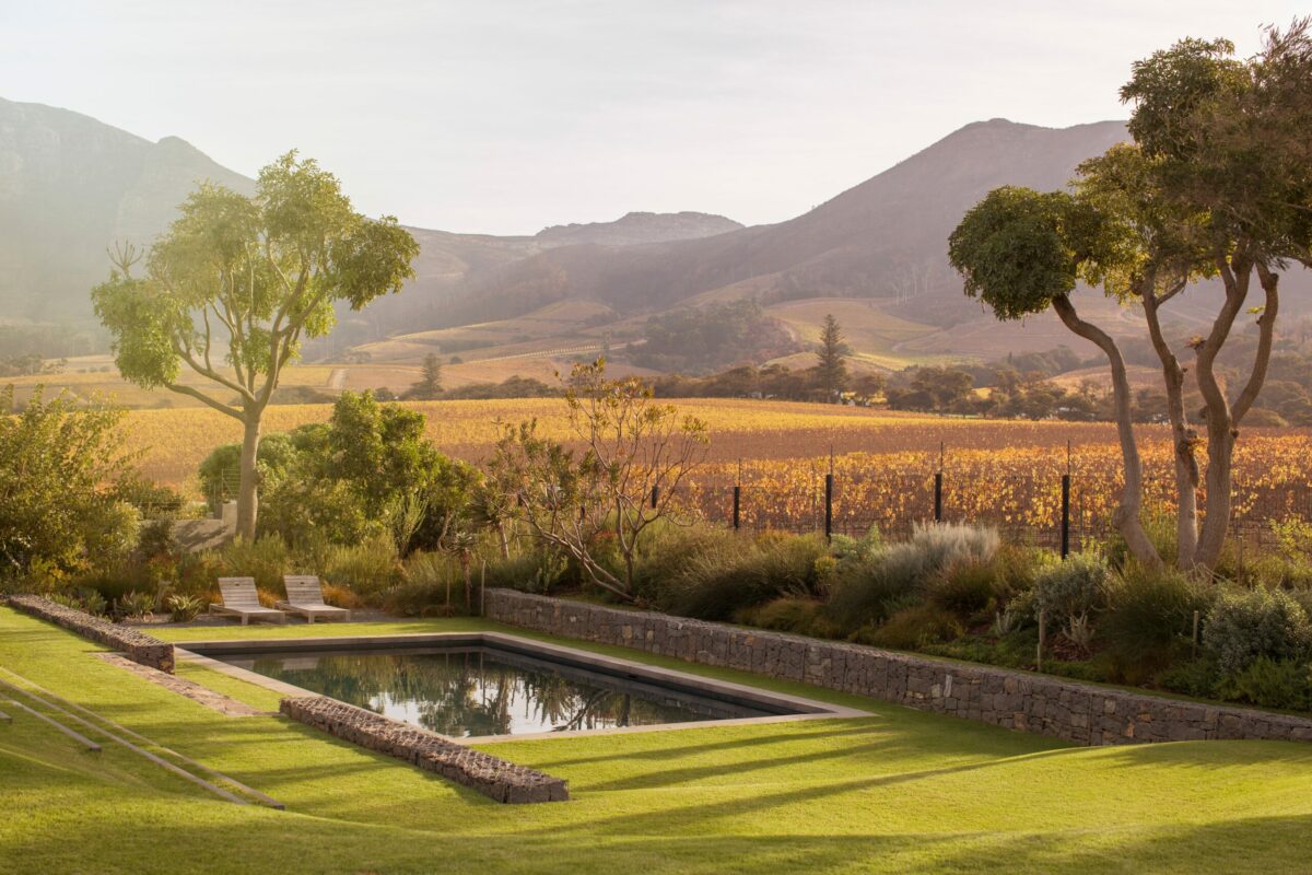 Landscape view of fields, luxury pool, landscaping on a high end estate